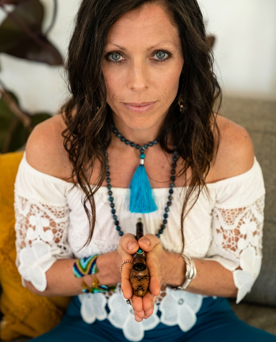 Dr. Shelly Persad holding a sacred Cannabis pipe